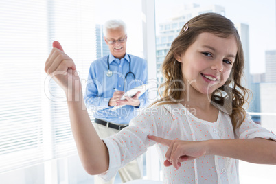 Portrait of girl flexing his biceps in the clinic