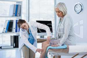 Doctor examining patient knee