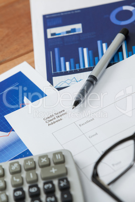 Paper document with business graph, pen, calculator and spectacle