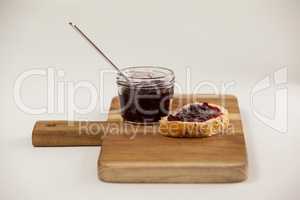 Bread with jam on cutting board