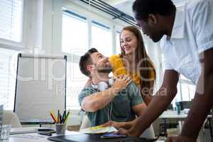 Graphic designers interacting at their desk