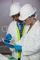 Technicians looking at digital tablet