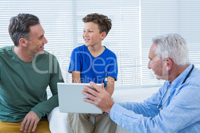 Doctor and patient discussing over digital tablet