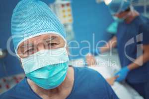 Portrait of male surgeon wearing surgical mask in operation theater