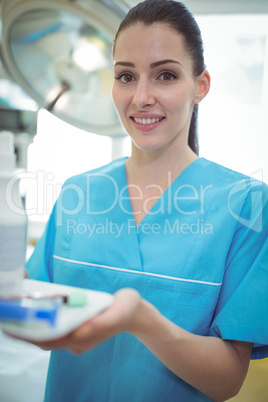 Portrait of nurse holding samples in tray