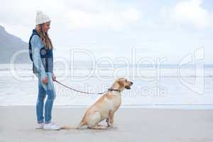 Woman standing with pet dog