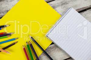 Yellow placard, color pencils and notepad