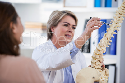 Doctor explaining anatomical spine to patient