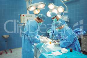 Team of surgeons performing operation in operation theater