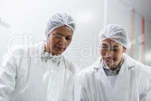 Female butcher working at meat factory