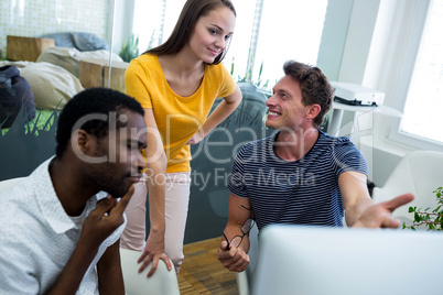 Graphic designers working on computer at desk