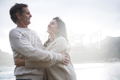 Romantic couple embracing each other on beach