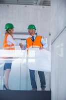 Architects shaking hands in office corridor