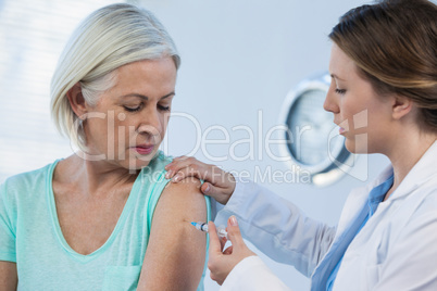 Doctor giving injection to patient