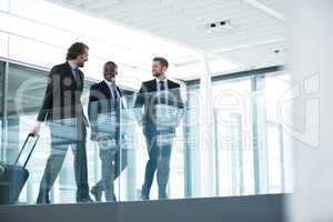 Businessman talking with colleagues while walking