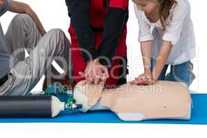 Paramedic training cardiopulmonary resuscitation to girl