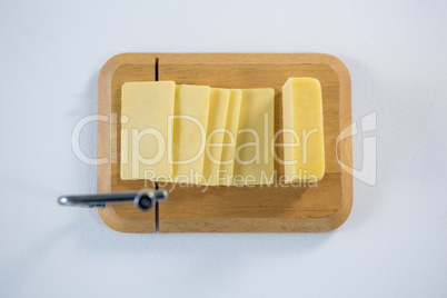 Cheese cutting board with slices of cheese