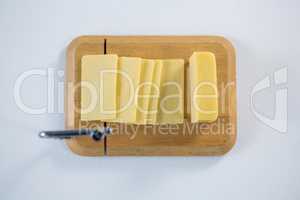 Cheese cutting board with slices of cheese