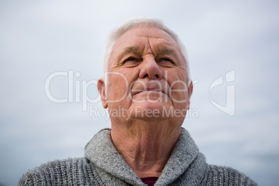 Thoughtful senior man standing