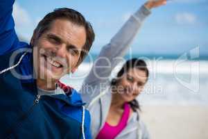 Couple performing stretching exercise