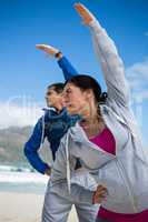 Couple performing stretching exercise