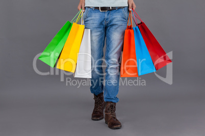 Man holding colourful shopping bags