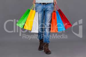Man holding colourful shopping bags