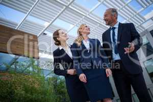 Confident businesspeople standing in the office premises