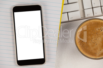 Cup of coffee with keyboard, mobile phone and notepad