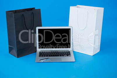 Shopping bags and credit card with laptop