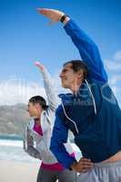 Couple performing stretching exercise