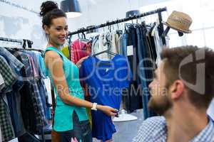 Woman showing clothes to man