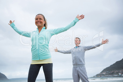 Couple performing stretching exercise