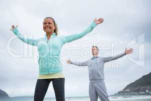 Couple performing stretching exercise