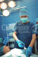 Male surgeon performing operation in operation theater