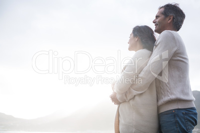 Romantic couple embracing each other on beach