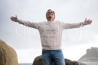 Happy man standing with arms outstretched Happy man standing with arms outstretched