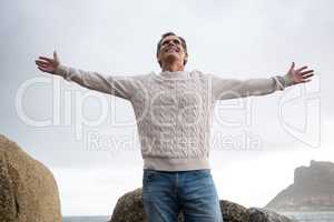 Happy man standing with arms outstretched