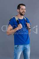 Happy man in blue t-shirt with backpack