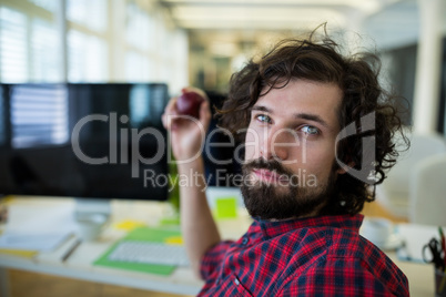 Business executive holding apple