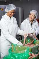 Female butchers processing sausages