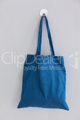 Blue bag hanging on wall