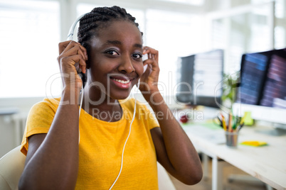 Portrait of woman listening to music on headphones