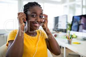 Portrait of woman listening to music on headphones
