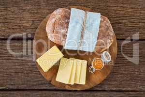 Slices of cheese and bread on wooden board
