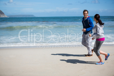 Mature couple jogging on beach