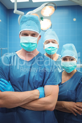Team of surgeons standing in operation theater
