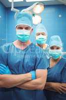 Team of surgeons standing in operation theater