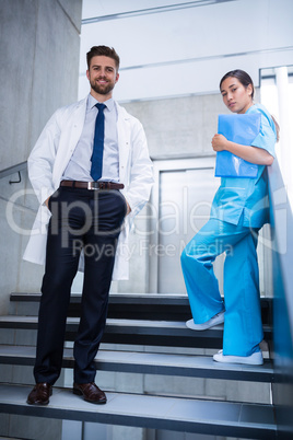 Doctor and nurse standing on staircase