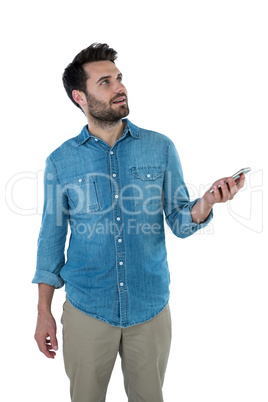 Man dreaming while holding a mobile phone